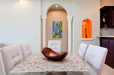 a dining room with a glass table with a bowl on it at Matapalo Diria #504 Amazing Condo-Ocean View in Tamarindo