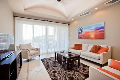 a living room with a couch and a table at Matapalo Diria #504 Amazing Condo-Ocean View in Tamarindo