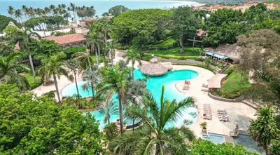 an aerial view of a pool at a resort at Matapalo Diria #504 Amazing Condo-Ocean View in Tamarindo