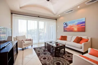 a living room with a couch and a table at Matapalo Diria #504 Amazing Condo-Ocean View in Tamarindo