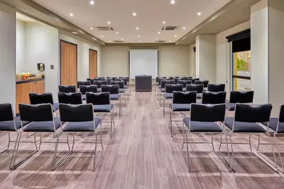 a conference room with chairs and a podium at City Express by Marriott San José Costa Rica in San José