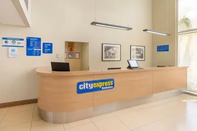 a lobby with a reception counter in a hospital at City Express by Marriott San José Costa Rica in San José