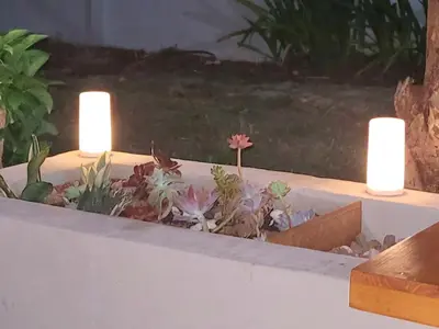 two candles in a succulent garden with plants at Casa Chayito in Santa María