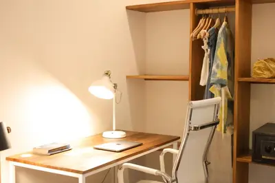 a desk in a room with a lamp and a chair at Outsite Santa Teresa Playa in Santa Teresa Beach