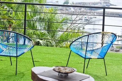 two blue chairs sitting on top of a balcony at Casa Federico in Quepos