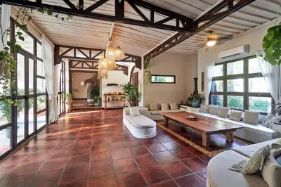 a large living room with couches and a table at Paradise Beach Lodge in Mal País