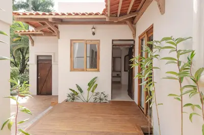 a home with a porch with a wooden deck at Paradise Beach Lodge in Mal País