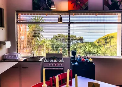 a kitchen with a stove and a sink and a window at Magic Mountain Views Studio in Atenas