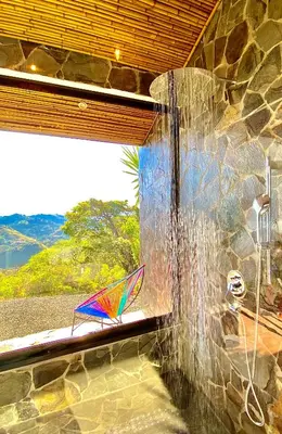 a shower with a colorful kite sitting in a window at Magic Mountain Views Studio in Atenas