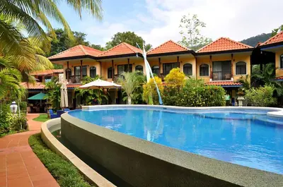 a hotel with a swimming pool in front of a building at Hotel Cuna del Angel in Uvita