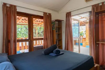a bedroom with a bed and a large window at 1 Bedroom G-Land Burnt Toast Surfcamp in Nosara