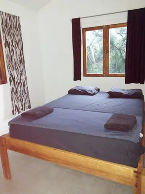 a bedroom with two beds and a window at 1 Bedroom G-Land Burnt Toast Surfcamp in Nosara