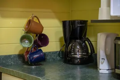 a kitchen counter with a coffee maker on a counter top at Alice y Juancito Boutique Hotel in Alajuela City