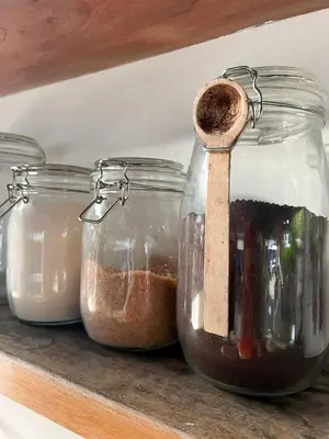 a row of jars of condiments on a shelf at Blue Surf Sanctuary in Santa Teresa Beach