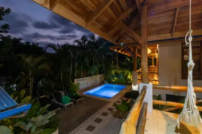 a backyard with a swimming pool and a house at Blue Surf Sanctuary in Santa Teresa Beach