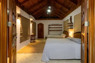 a bedroom with a bed and two beds in it at Blue Surf Sanctuary in Santa Teresa Beach