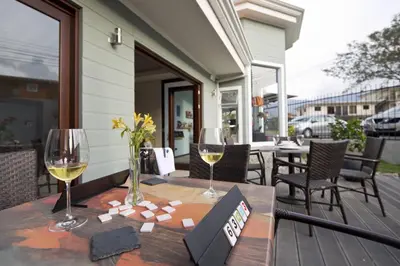 a table with two glasses of wine on a patio at Hotel Villa Los Candiles in San José