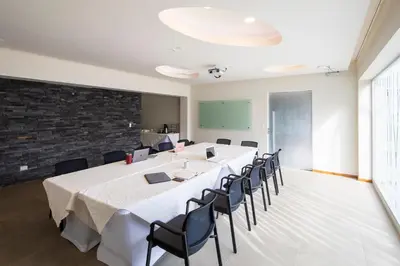a large conference room with a long table and chairs at Hotel Villa Los Candiles in San José