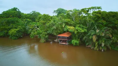 an aerial view of a house in the middle of a river at Evergreen Lodge in Tortuguero