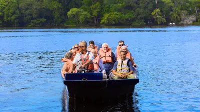 a group of people on a boat on a lake at Evergreen Lodge in Tortuguero