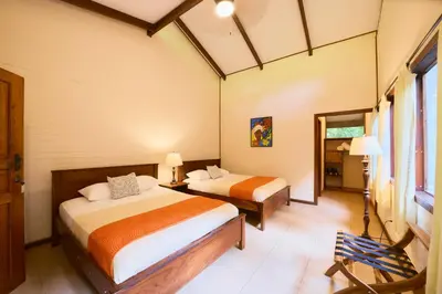 a bedroom with two beds in a room at Evergreen Lodge in Tortuguero