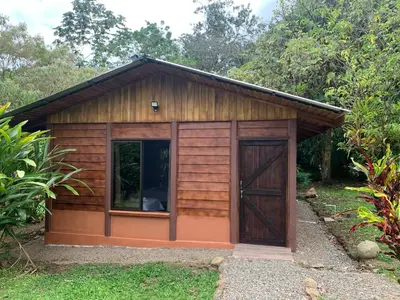 a small wooden shed with a large door at Cataratas Bijagua Lodge, incluye tour autoguiado Bijagua Waterfalls Hike in Bijagua