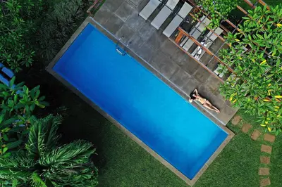 an overhead view of a person swimming in a swimming pool at Casa Frangipani in Montezuma