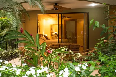 a living room with a couch and some plants at Monte Carlo Luxury Condominiums in Jacó