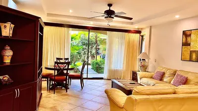 a living room with a couch and a table at Monte Carlo Luxury Condominiums in Jacó