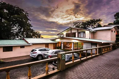 two cars parked in front of a house at Mar Inn Costa Rica in Monteverde Costa Rica