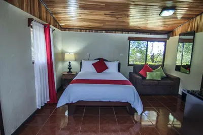 a bedroom with a bed and a couch at Mar Inn Costa Rica in Monteverde Costa Rica