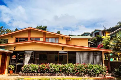 a house with flowers in front of it at Mar Inn Costa Rica in Monteverde Costa Rica