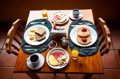 a table with plates of breakfast food on it at Mar Inn Costa Rica in Monteverde Costa Rica