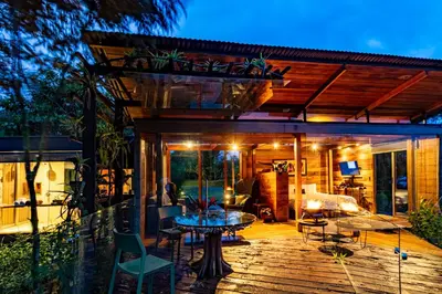 a patio with a table and chairs on a deck at Ecolirios Boutique Hotel & Villas in Guácimo