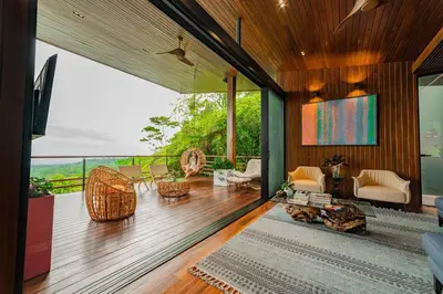 a living room with a view of the ocean at Ecolirios Boutique Hotel & Villas in Guácimo