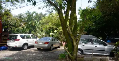a group of cars parked in a parking lot at ApartHotel Villa Pacande & Rooms in Alajuela City