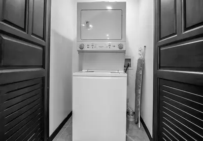 a washer and dryer in a room next to a door at Oceanfront The Palms Jaco in Jacó