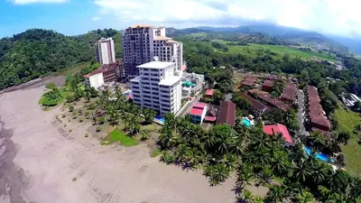 an aerial view of a building on a beach at Oceanfront The Palms Jaco in Jacó