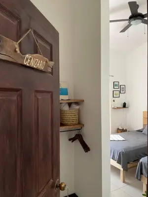 a door with a sign on it in a bedroom at El Chante Surf House in Santa Teresa Beach