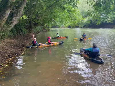a group of people in kayaks on a river at Iguanitas Lodge in Pital