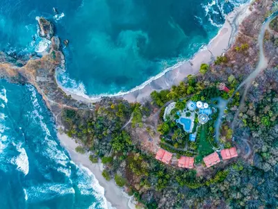 an aerial view of a house on the beach at Nosara Beach Hotel in Nosara