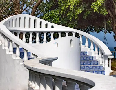 a white staircase with blue stairs at Nosara Beach Hotel in Nosara