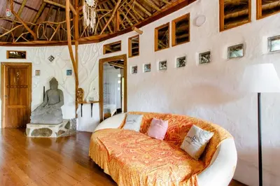 a bedroom with a bed and a statue in it at Poolvilla in Platanillo