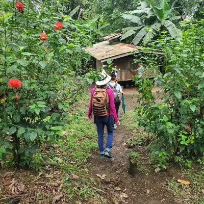 a group of people walking down a dirt trail at Rancho Margot Sustainable & Self Sufficient Eco Lodge in El Castillo de La Fortuna