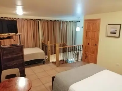 a hotel room with a bed and a crib at Apartotel Don Francisco in San José