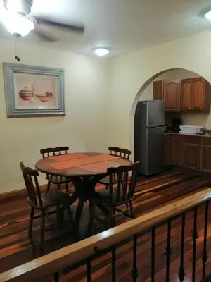 a kitchen with a table and chairs and a refrigerator at Apartotel Don Francisco in San José