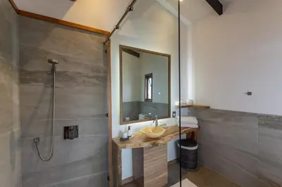 a bathroom with a shower and a sink and a mirror at Vista del Alma Boutique - Adult Only in Santa Teresa Beach