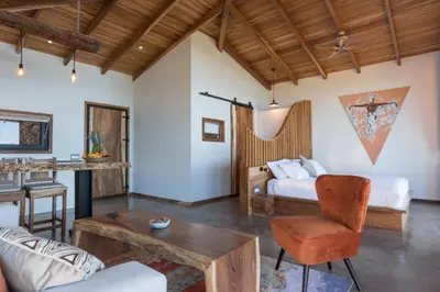 a living room with a bed and a table at Vista del Alma Boutique - Adult Only in Santa Teresa Beach