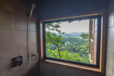 a bathroom with a window with a view at Vista del Alma Boutique - Adult Only in Santa Teresa Beach