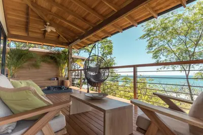 a room with a balcony with a view of the ocean at Vista del Alma Boutique - Adult Only in Santa Teresa Beach